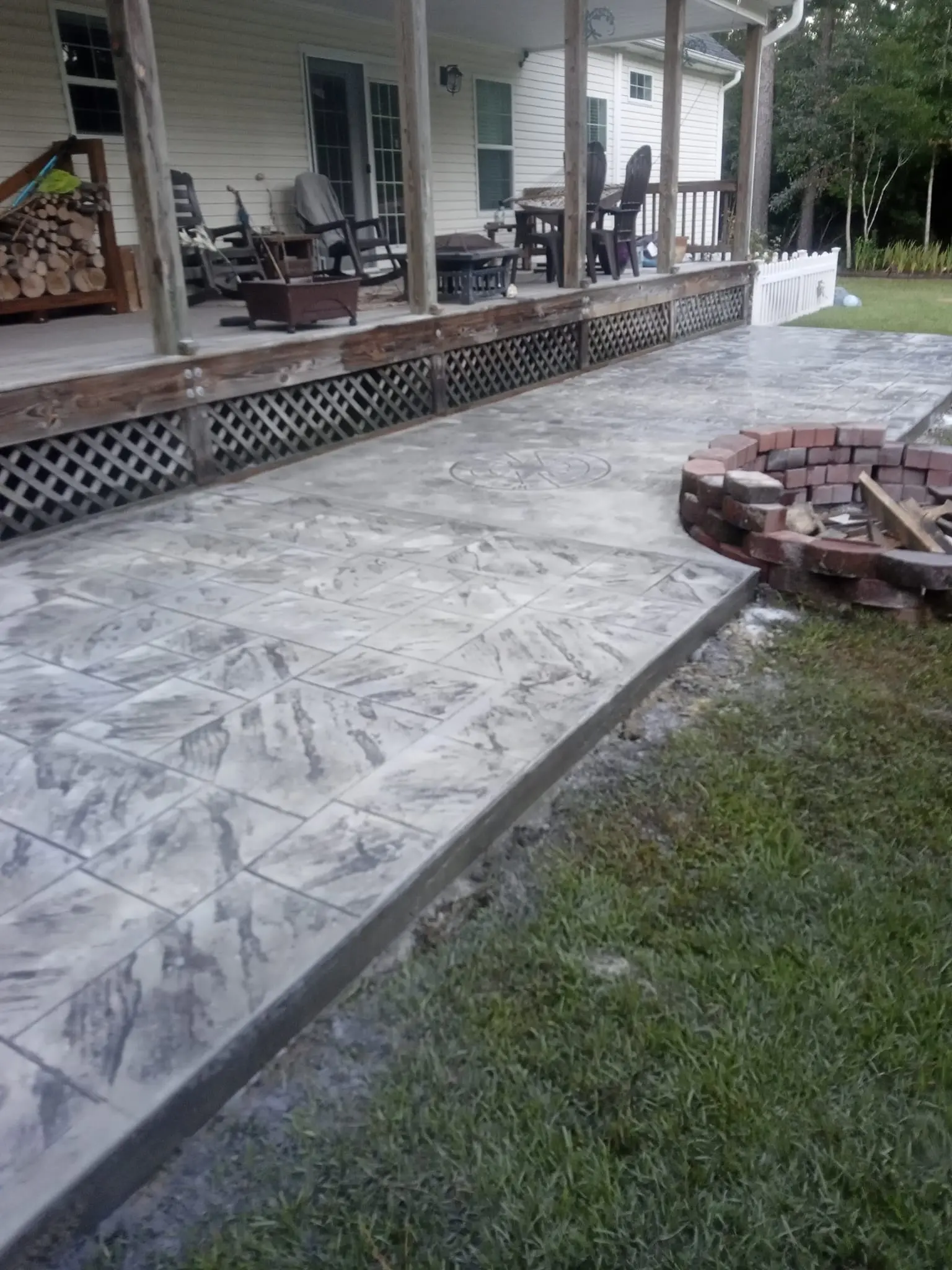 Stamped concrete fire pit and hardscape patio by Kolbie Lee's Concrete